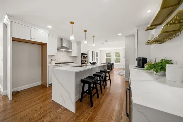 a kitchen with a table chairs refrigerator and cabinets