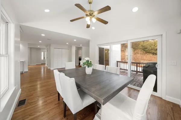 a view of a dining room and livingroom with furniture a rug