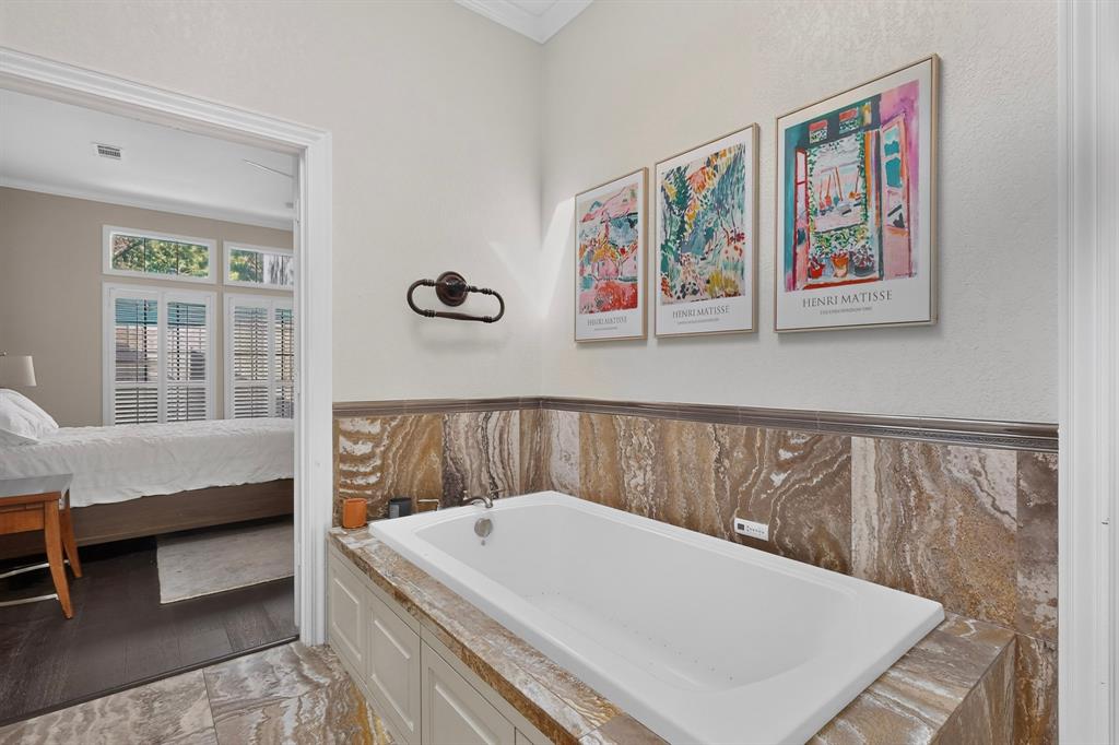 1526 Abrams Road Dallas, TX 75214 - Photo 20 of 38 Soaking tub with a tiled surround, paneled tub base, and coordinating floor tile