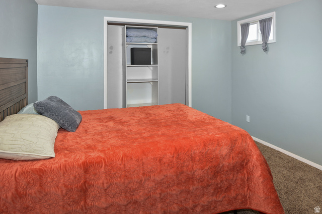 315 Park Street Inkom, ID 83245 - Photo 21 of 28 Bedroom featuring light blue walls, recessed ceiling lighting, a window with white trim, and a built-in closet with shelving