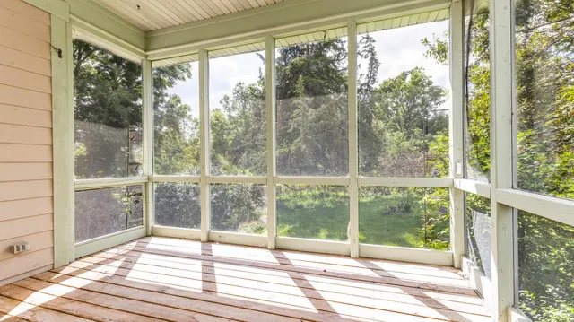 a view of a room with wooden floor and windows