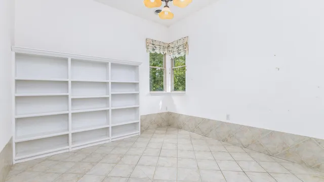 a view of room with window and shelf