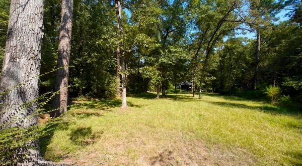 a view of a swimming pool with an outdoor seating and a yard