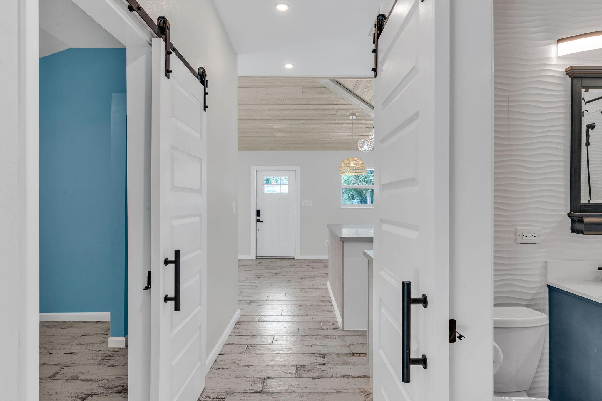 218 Lignumvitae Drive Key Largo, FL 33037 - Photo 12 of 35 a view of a hallway with wooden floor and staircase