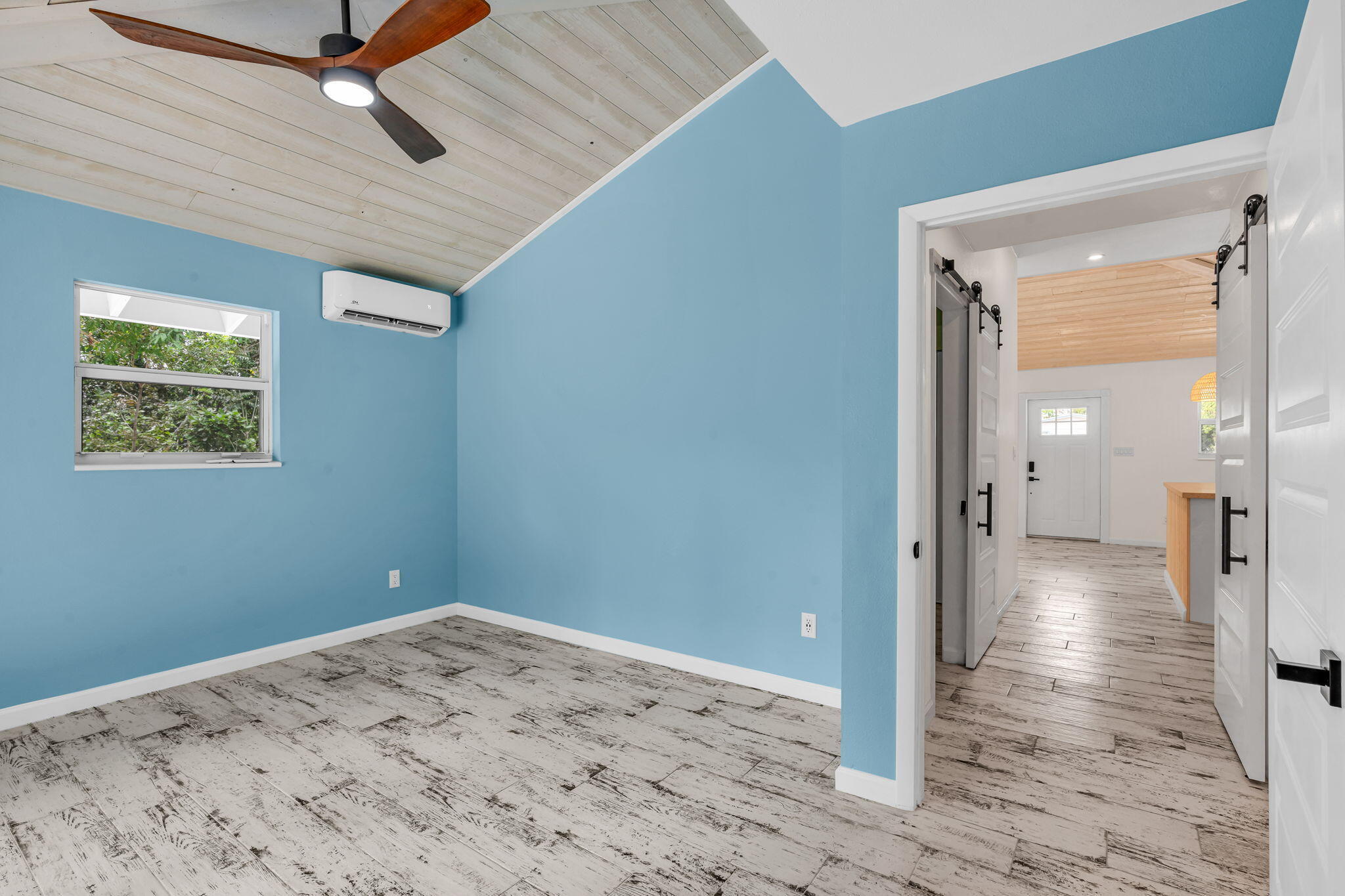 218 Lignumvitae Drive Key Largo, FL 33037 - Photo 16 of 35 a view of a big room with wooden floor and windows