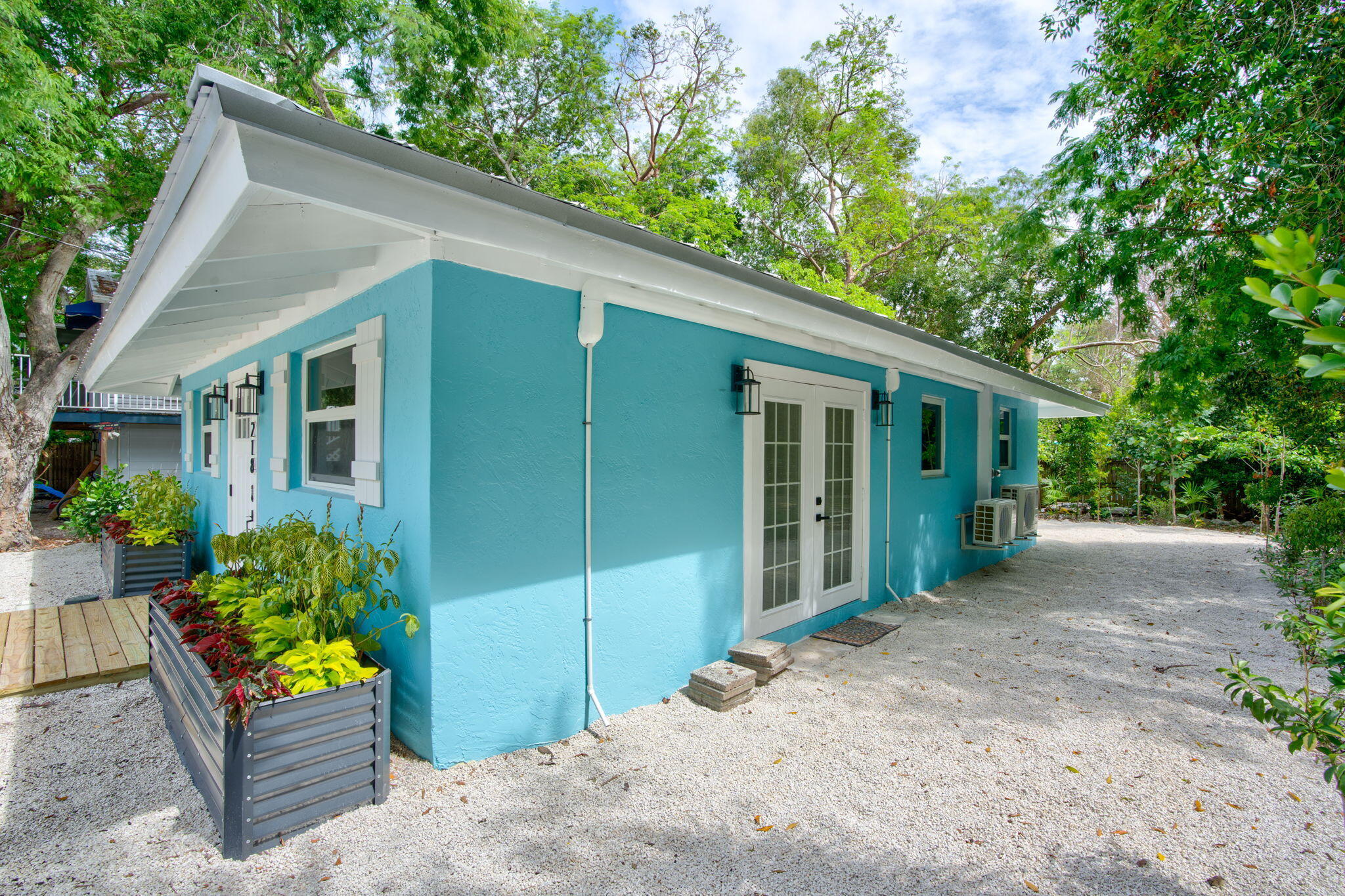 218 Lignumvitae Drive Key Largo, FL 33037 - Photo 25 of 35 a view of a house with outdoor seating area and garden