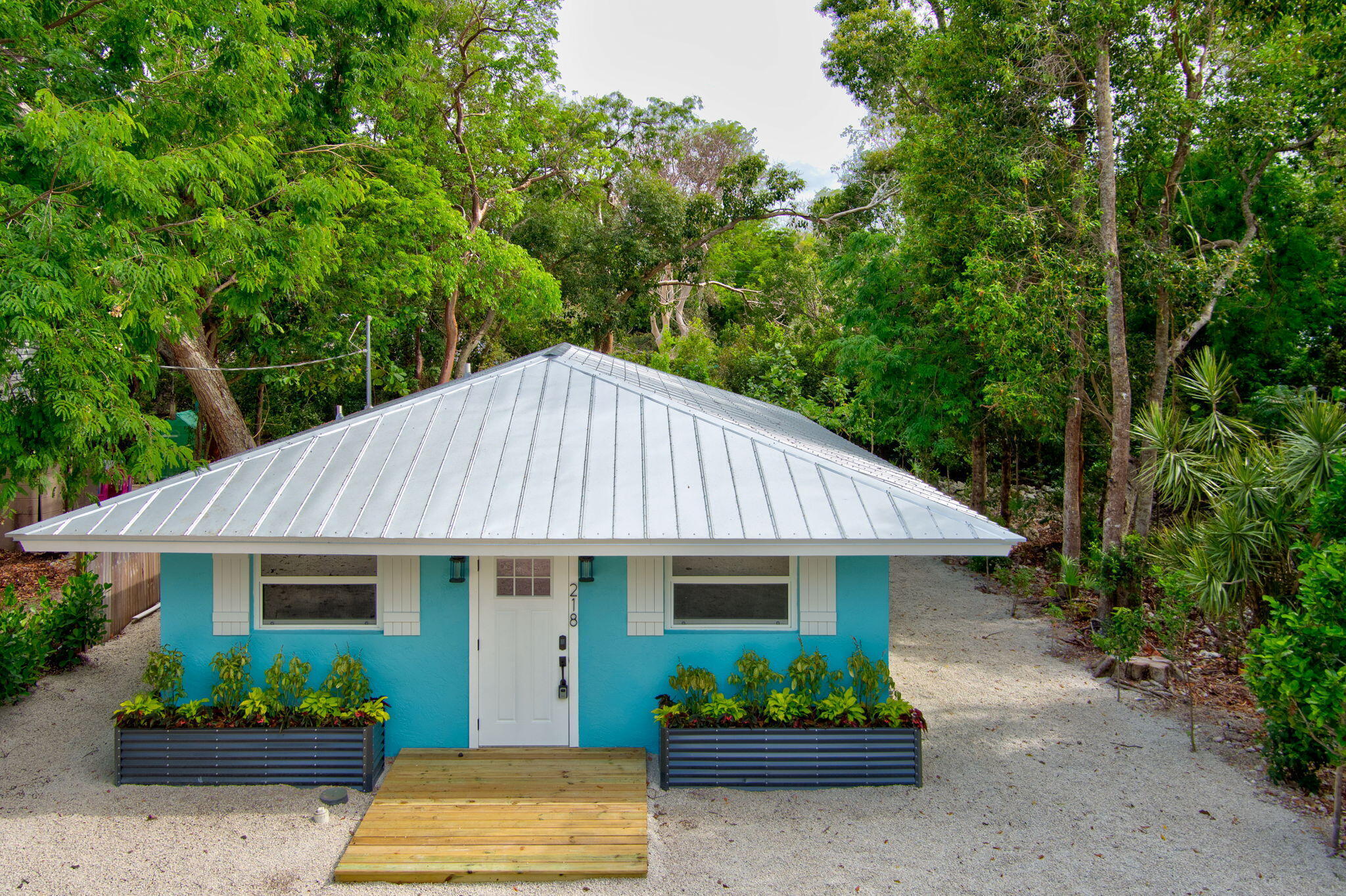 218 Lignumvitae Drive Key Largo, FL 33037 - Photo 35 of 35 a view of a house with lots of plants and a garden