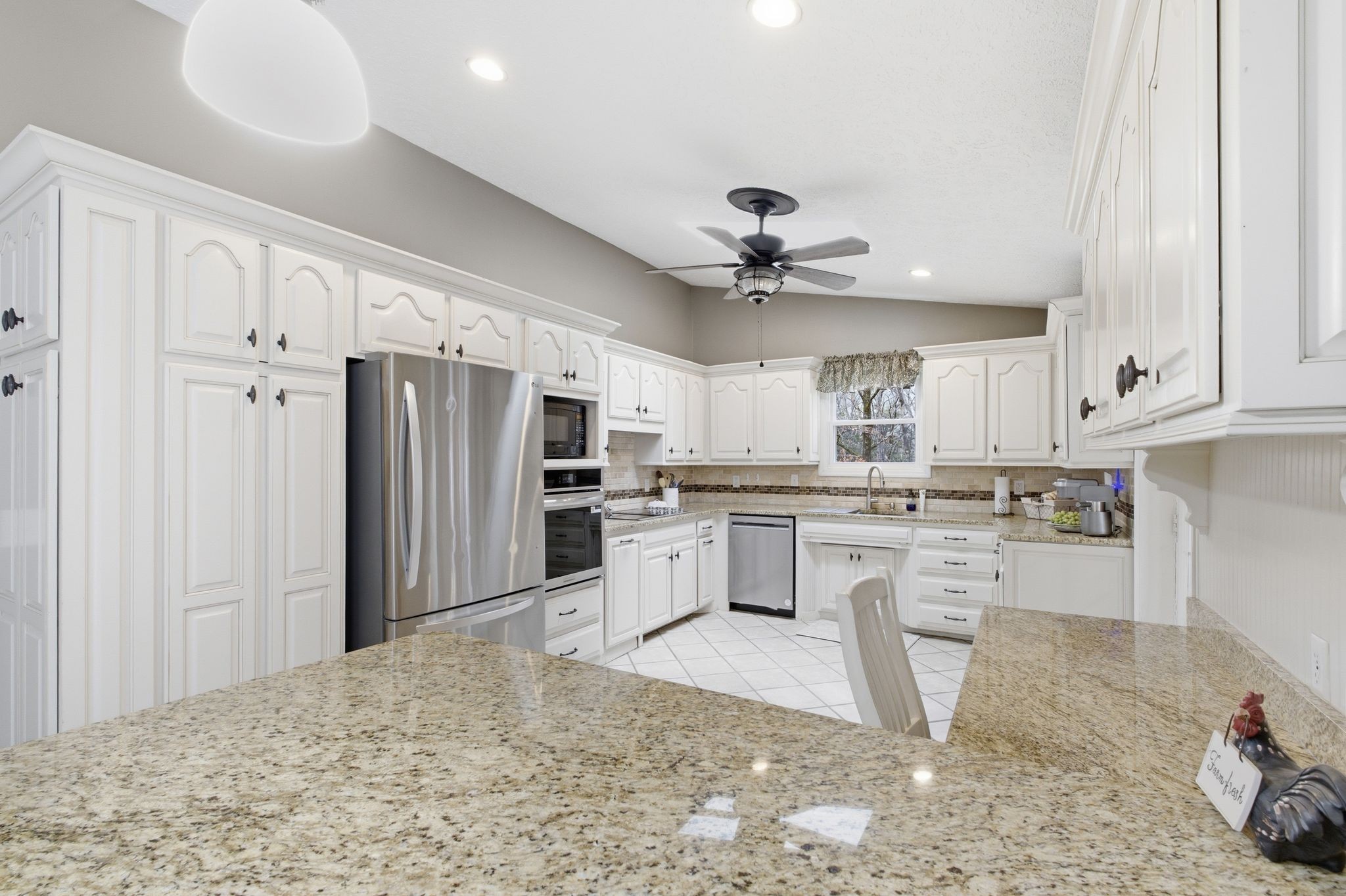 4708 Hessey Road Mount Juliet, TN 37122 - Photo 5 of 44 a kitchen with white cabinets and stainless steel appliances