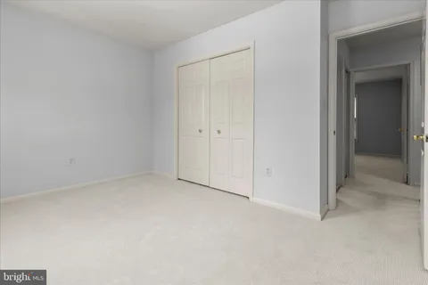 a view of a house with a yard and large tree