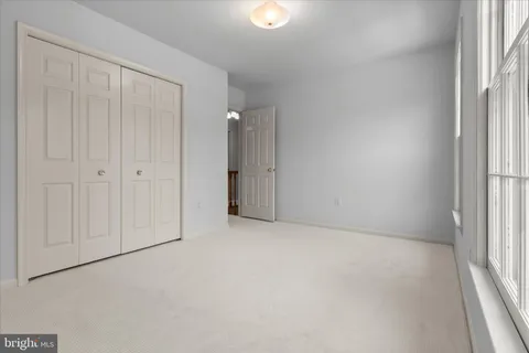 a view of a house with a large window and a yard