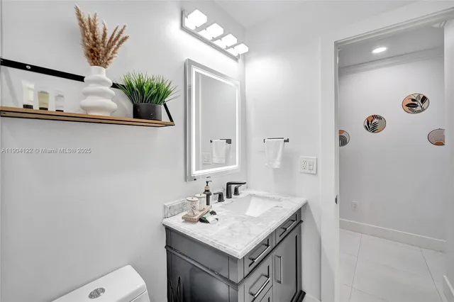 a bathroom with a shower sink a mirror and vanity