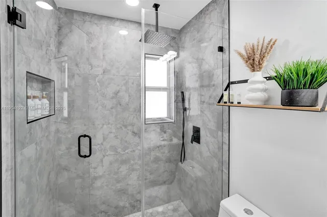 a bathroom with a toilet and a shower