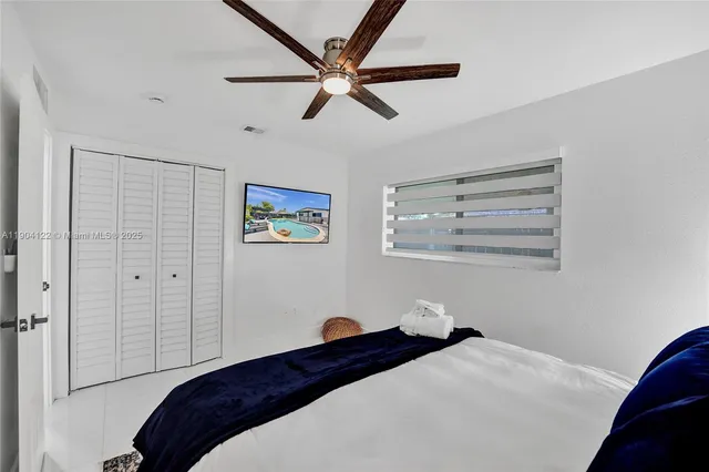 a bedroom with a bed and painting on the wall