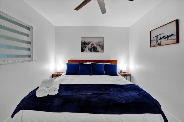 a bedroom with a bed and paintings on the wall