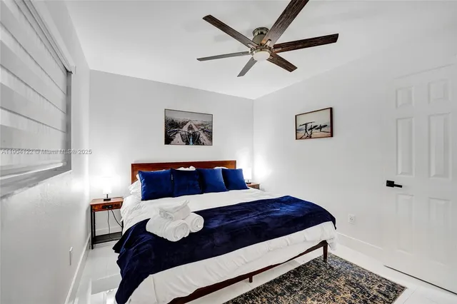 a bedroom with a bed and a painting on the wall