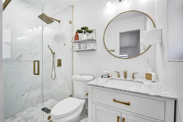 a white toilet sitting next to a bath tub shower