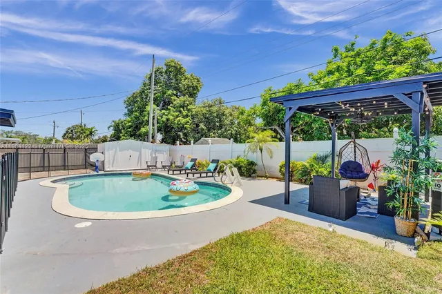 a view of backyard with plants and outdoor seating