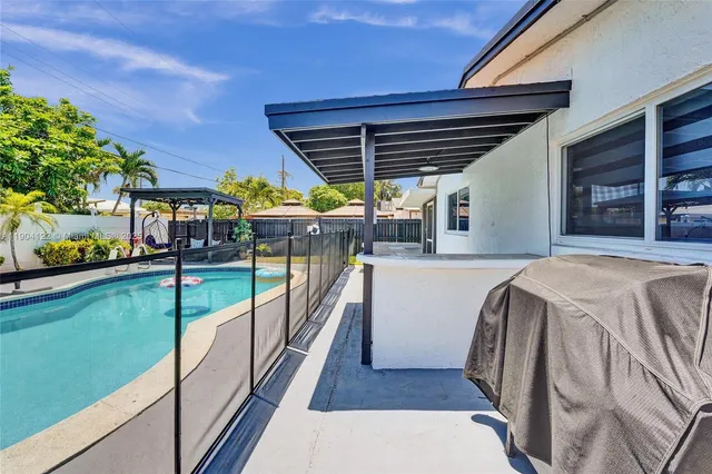 a view of a swimming pool with outdoor seating
