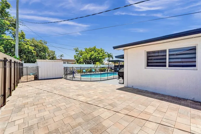 a view of a house with swimming pool and sitting area