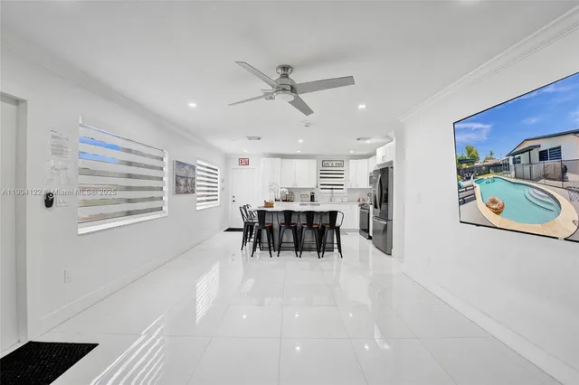 a living room with furniture and a dining table with kitchen view