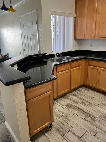a kitchen with granite countertop cabinets stainless steel appliances and a counter space