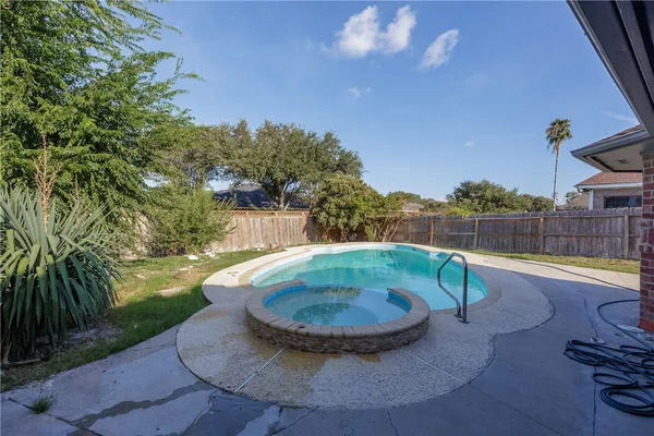 a view of a swimming pool with a yard
