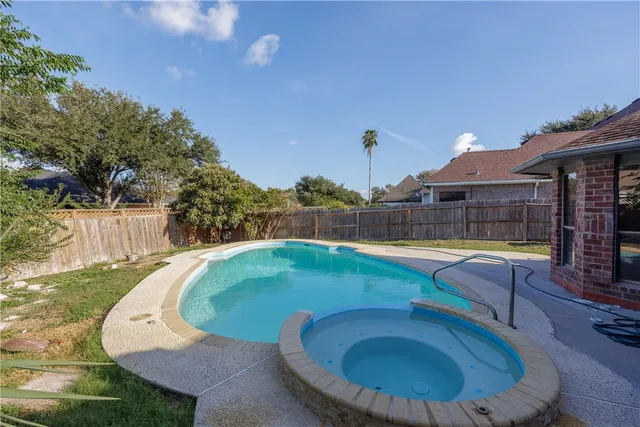 a front view of a house with yard patio and green space