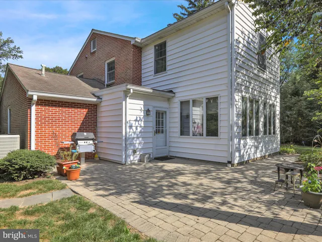a front view of a house with yard and green space