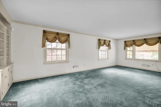 a view of empty room with window and fireplace