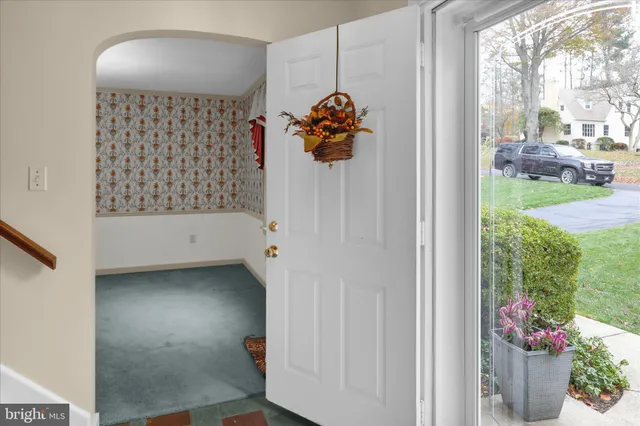 a kitchen with stainless steel appliances kitchen island granite countertop a sink and dishwasher a refrigerator with wooden cabinets