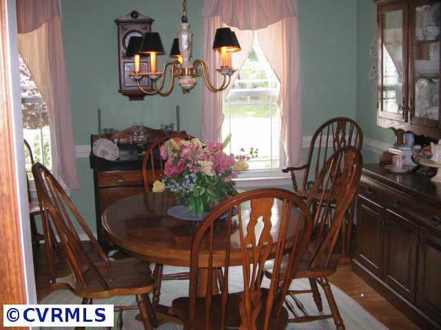 10818 Crofton Road Chester, VA 23831 - Photo 3 of 7 a view of a dining room with furniture and chandelier