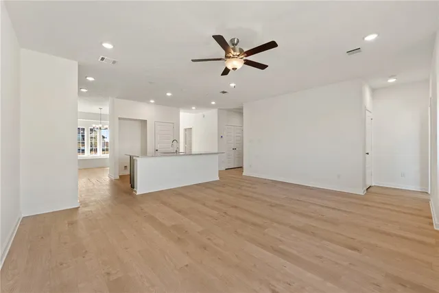 an empty room with windows and closet