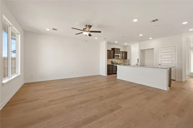 a view of an empty room with a window