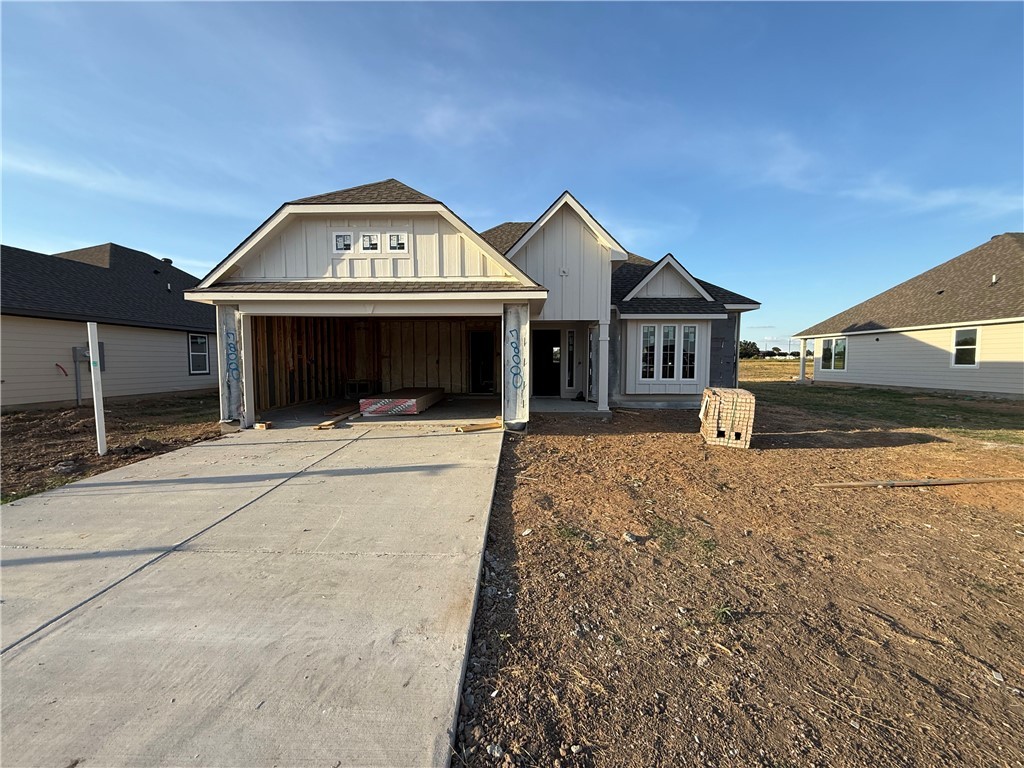 7808 Redbud Road Navasota, TX 77868 - Photo 2 of 8 View of front of property with board and batten siding, concrete driveway, a shingled roof, and an attached garage