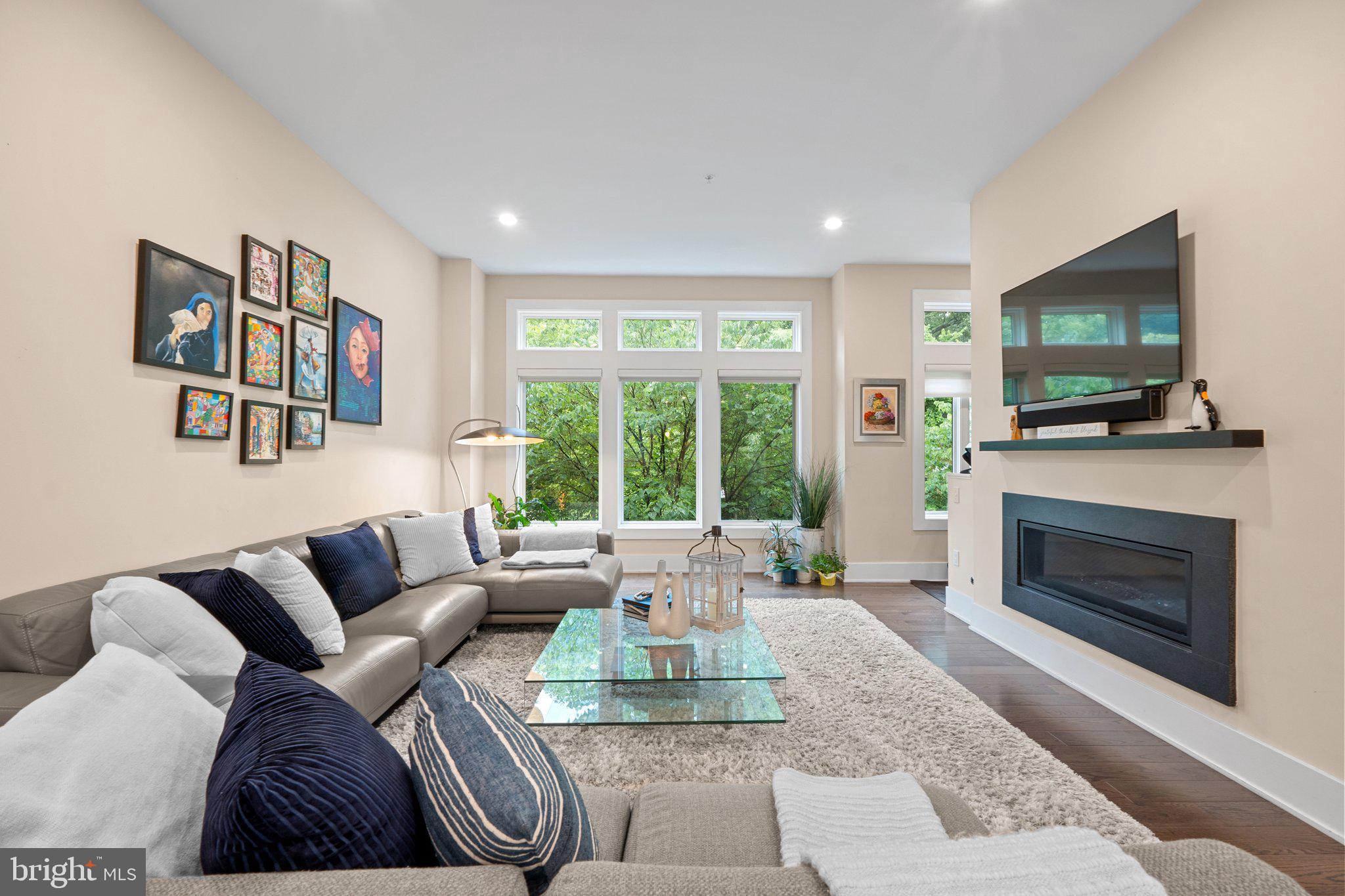 5307 Merriam Street Bethesda, MD 20814 - Photo 13 of 32 a living room with furniture a flat screen tv and a fireplace