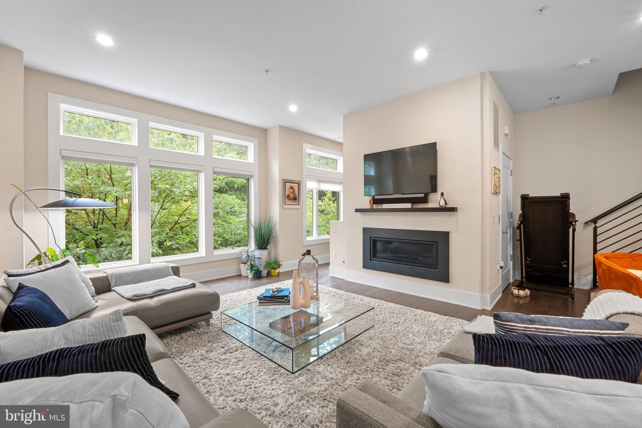 5307 Merriam Street Bethesda, MD 20814 - Photo 14 of 32 a living room with furniture a fireplace and a flat screen tv