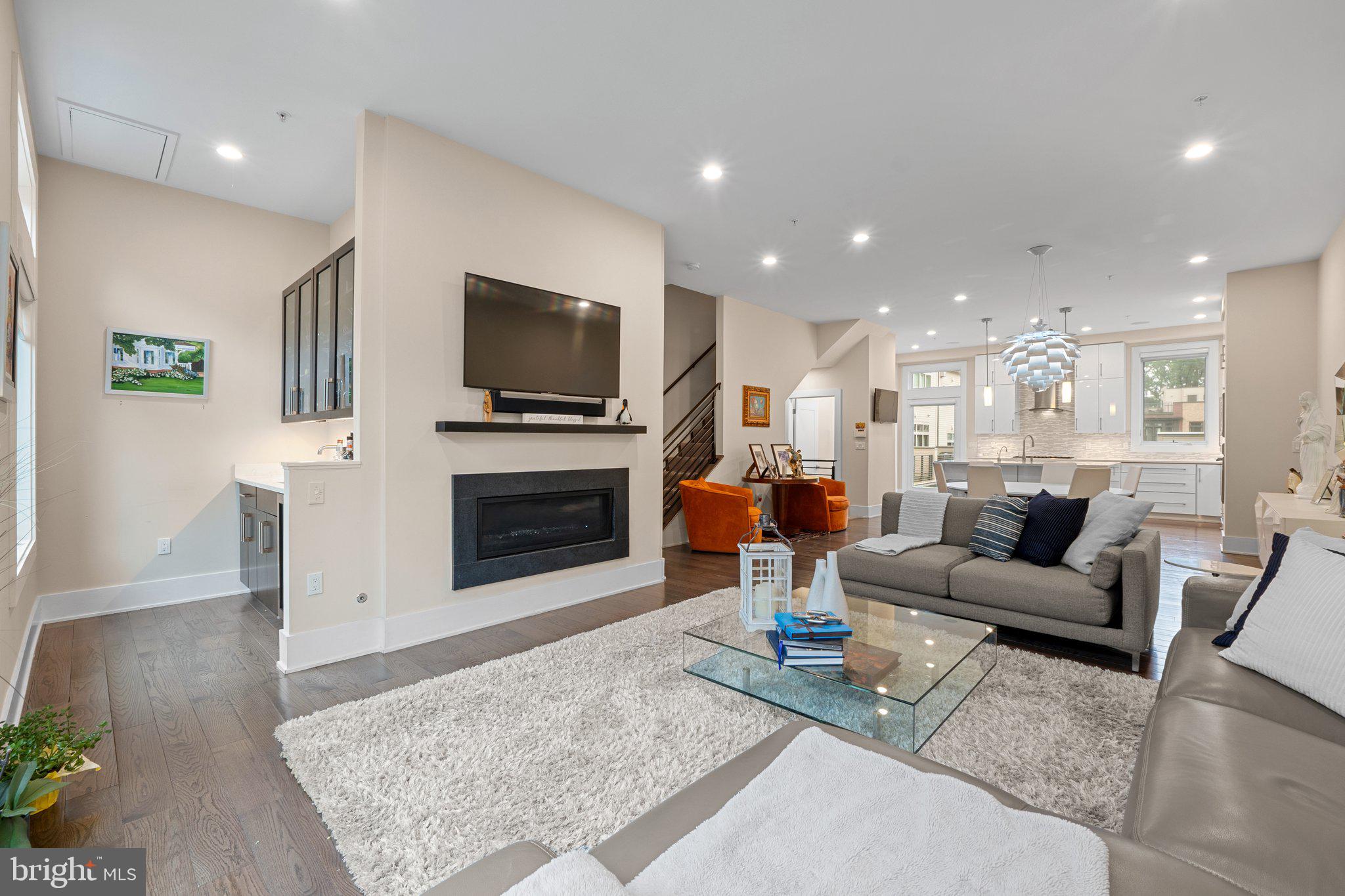 5307 Merriam Street Bethesda, MD 20814 - Photo 15 of 32 a living room with furniture a flat screen tv and a fireplace