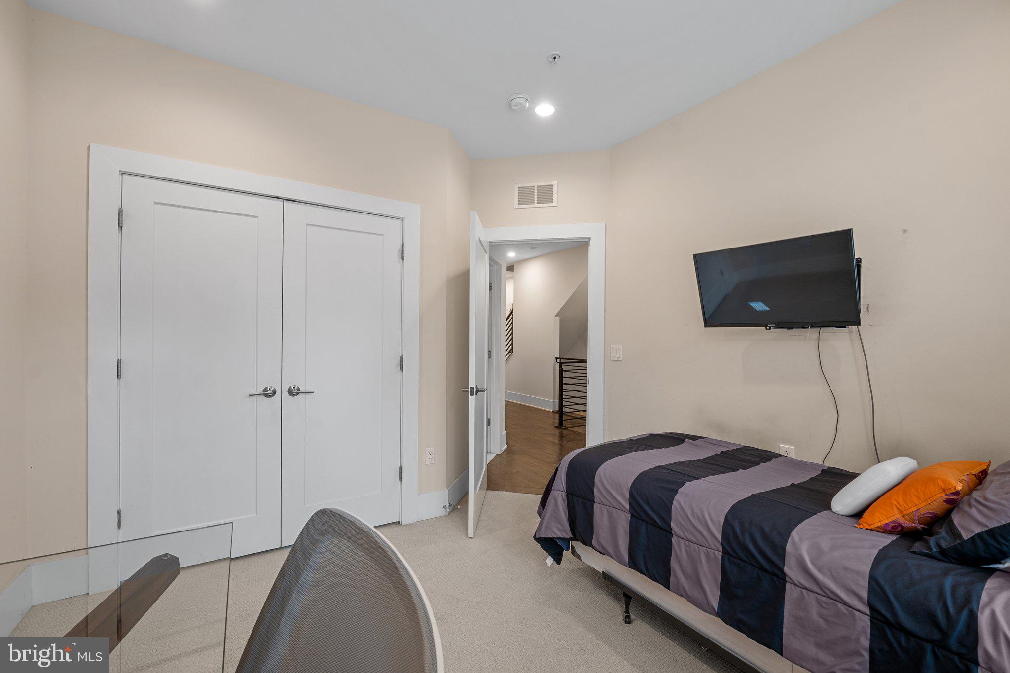 5307 Merriam Street Bethesda, MD 20814 - Photo 24 of 32 a bedroom with a bed and a flat screen tv