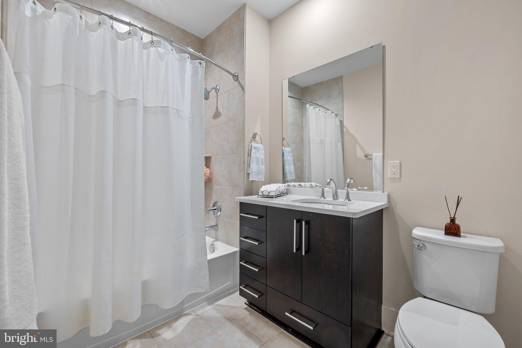 5307 Merriam Street Bethesda, MD 20814 - Photo 25 of 32 a bathroom with a sink a toilet and a mirror