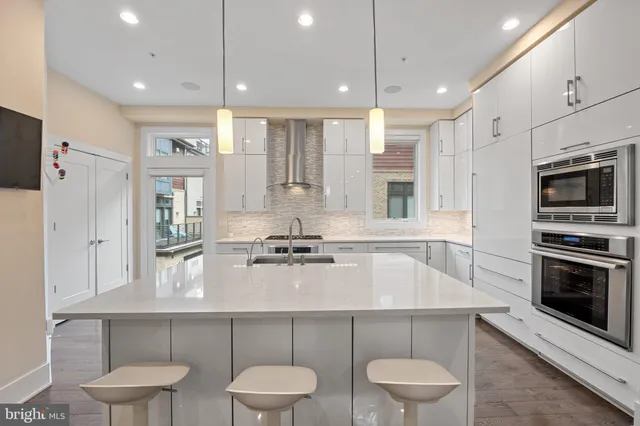 a kitchen with a table chairs stove and microwave