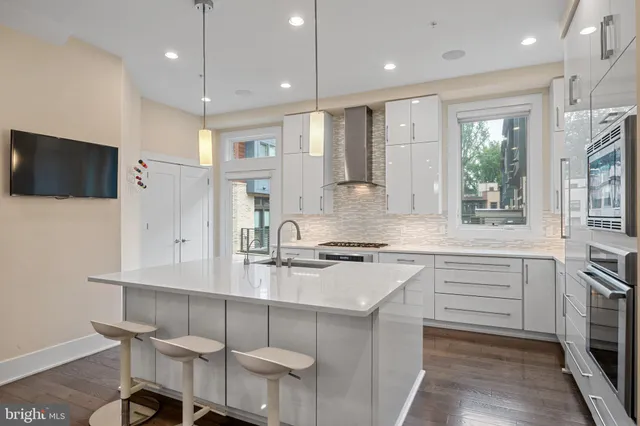 a kitchen with a sink cabinets and window