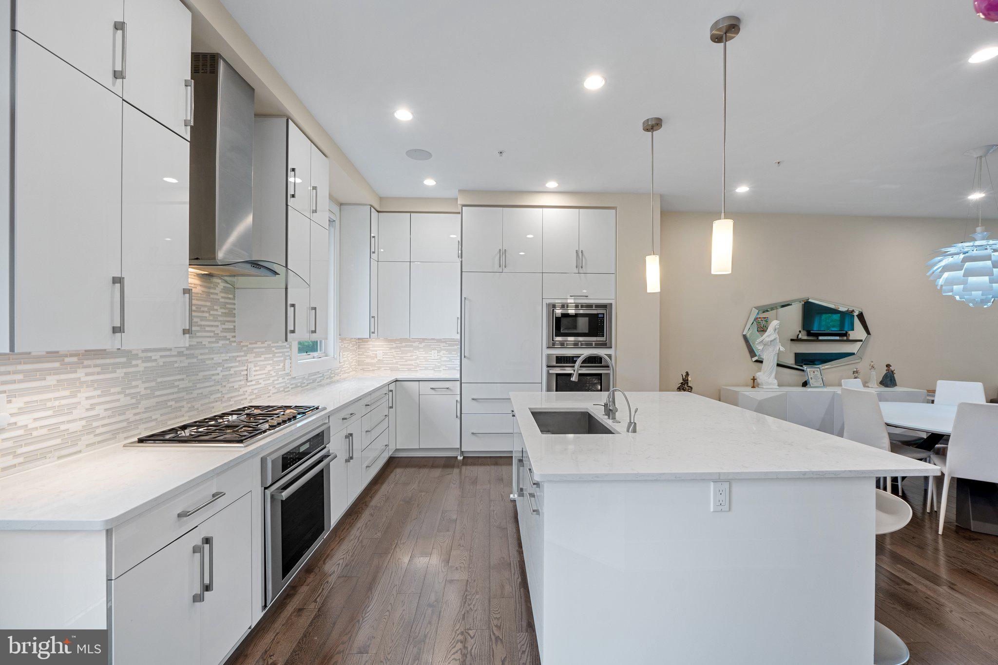 5307 Merriam Street Bethesda, MD 20814 - Photo 6 of 32 a kitchen with counter top space a sink stainless steel appliances and cabinets