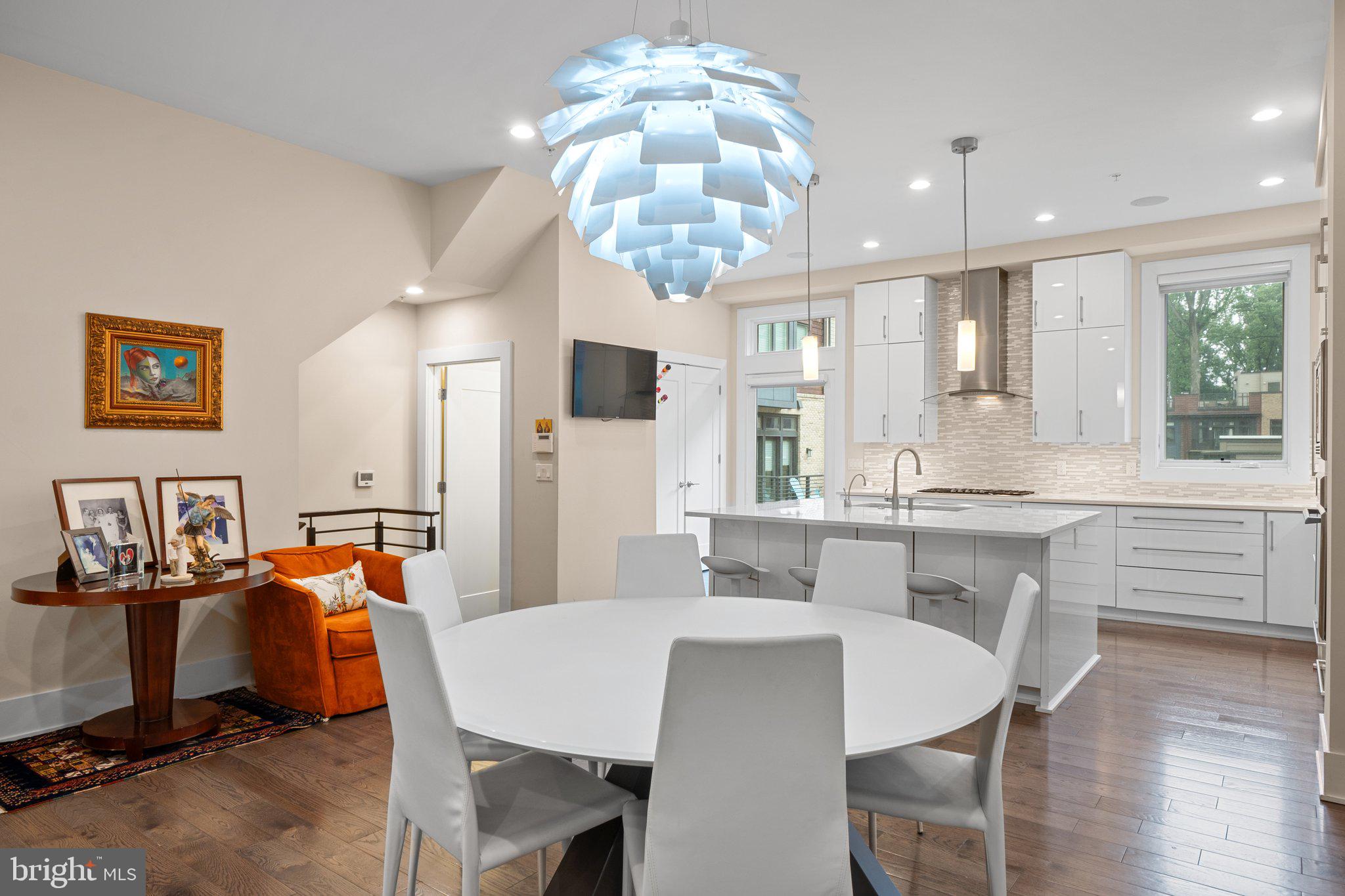 5307 Merriam Street Bethesda, MD 20814 - Photo 9 of 32 a large kitchen with kitchen island a dining table and chairs