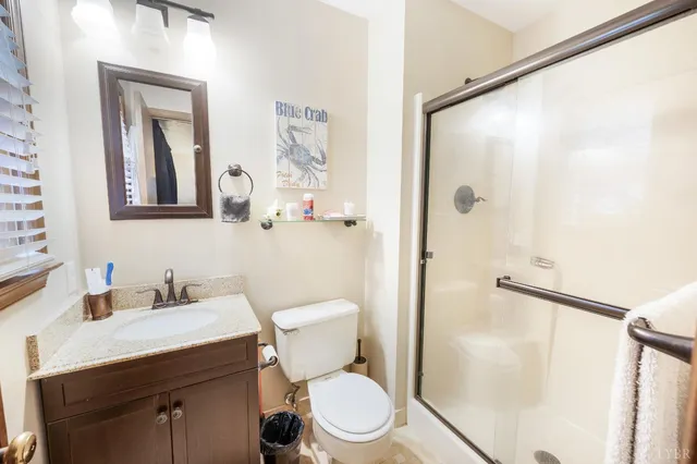 a bathroom with a toilet a sink and a mirror