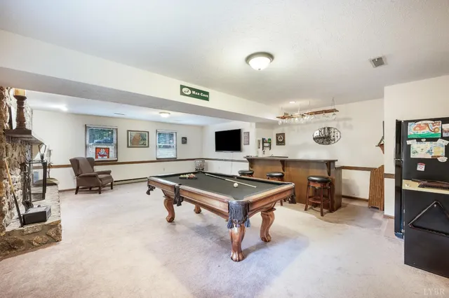 a living room with furniture pool and a flat screen tv