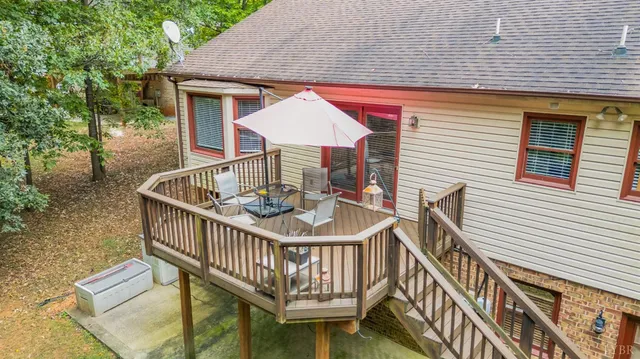 a view of a house with balcony and wooden stairs