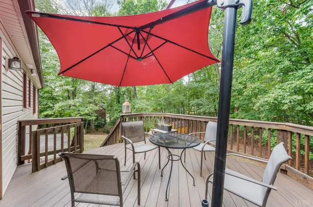 a view of balcony with wooden floor and outdoor seating