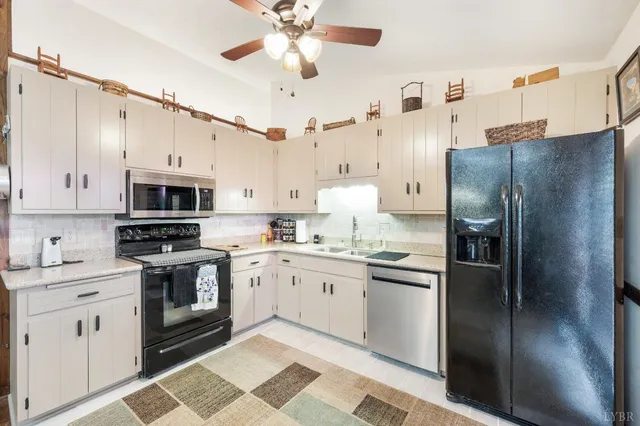 a kitchen with stainless steel appliances and chandelier