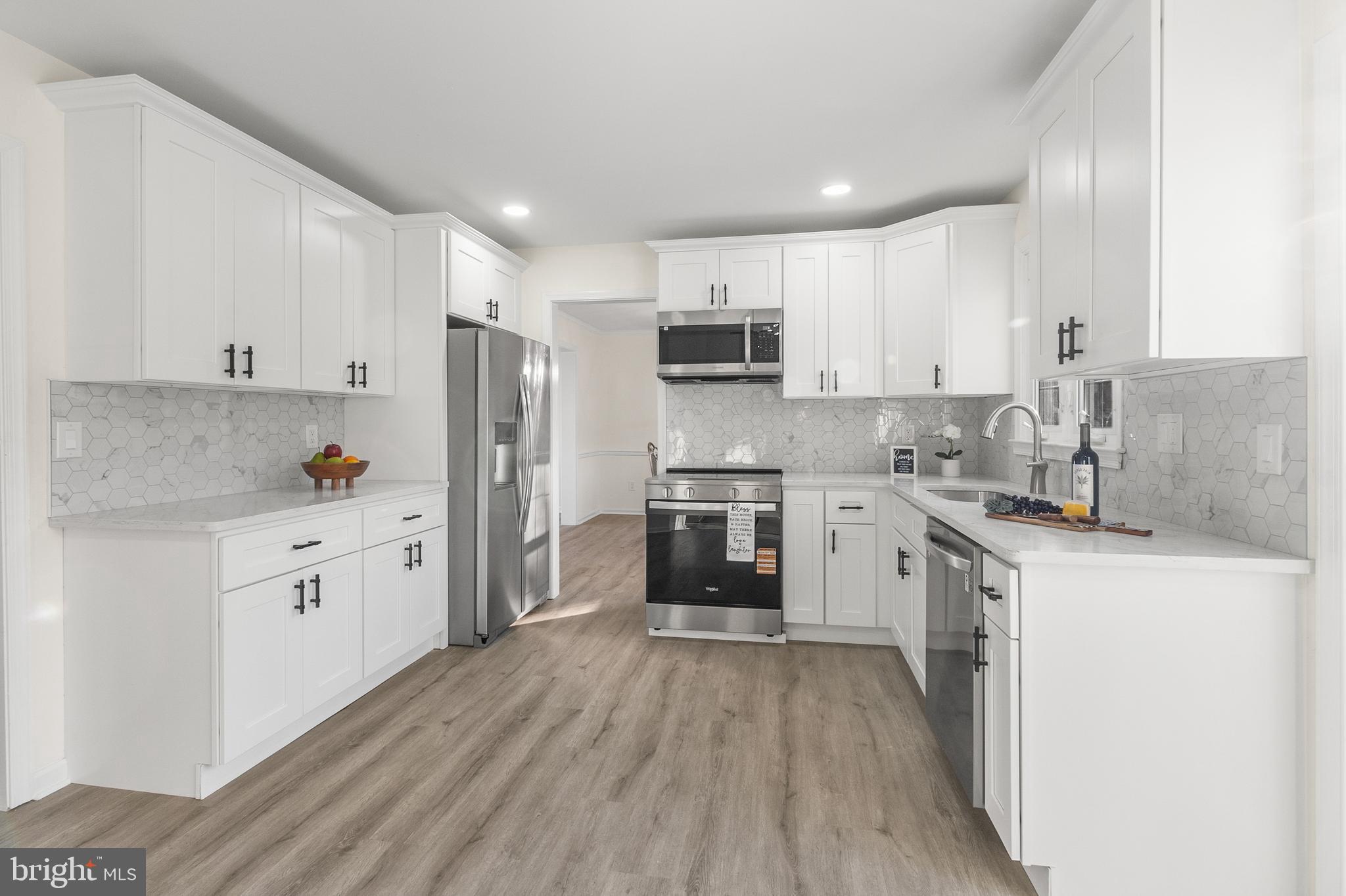 210 West Silver Fox Road Newark, DE 19702 - Photo 11 of 43 a kitchen with granite countertop white cabinets and stainless steel appliances