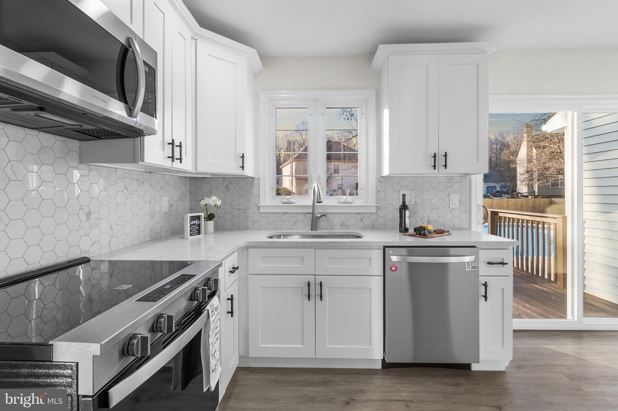 210 West Silver Fox Road Newark, DE 19702 - Photo 13 of 43 a kitchen with stainless steel appliances a sink stove and cabinets